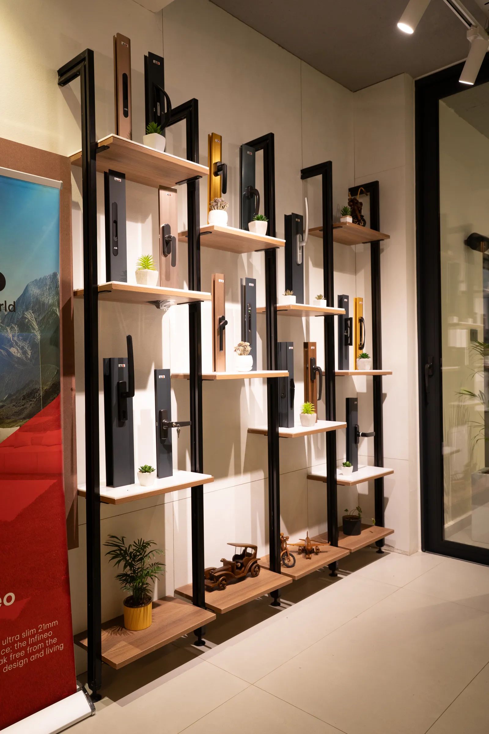 Hardware sample wall with lit shelves — Aluk Experience Center
